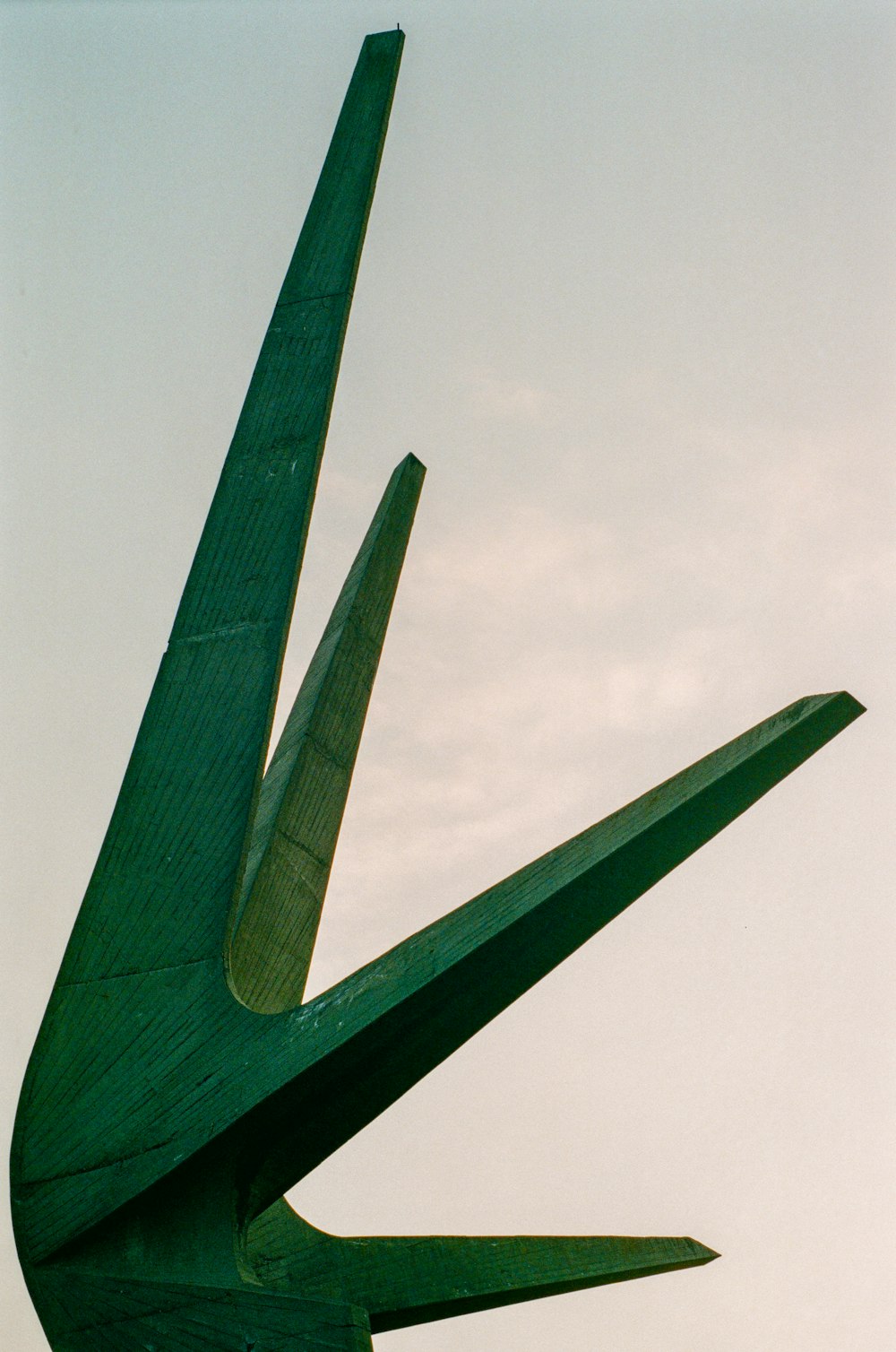 a sculpture of a bird made of wood
