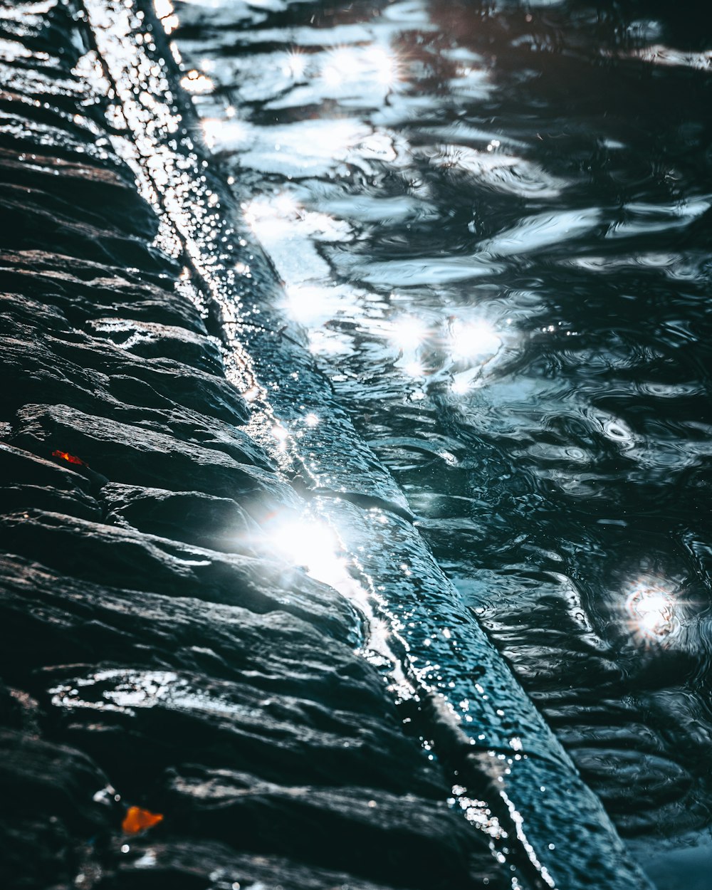 a close up of water with a light shining on it