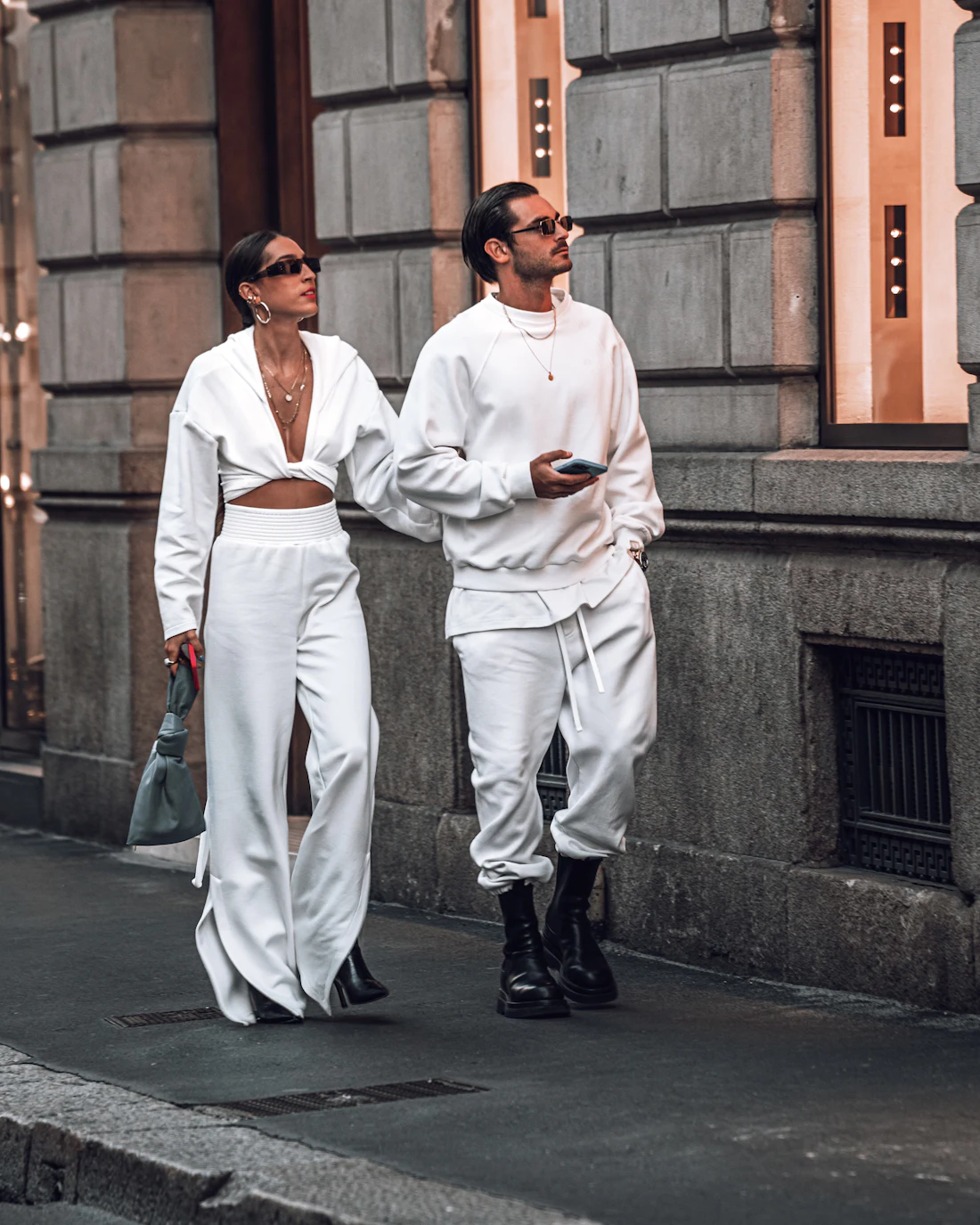 A relaxed, layered street-style outfit with trainers