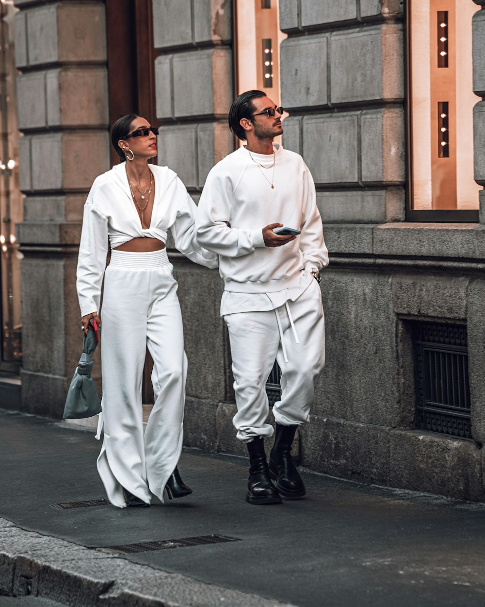 a man and a woman walking down the street