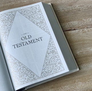 an open book with the words old testament on it