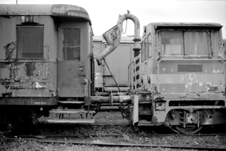 a black and white photo of old train cars