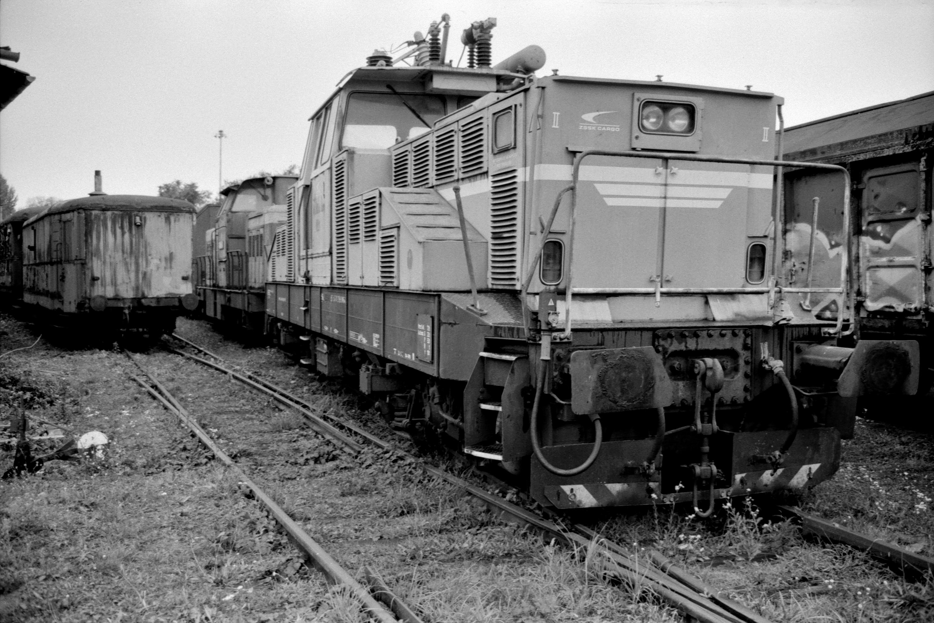 a black and white photo of a train on the tracks