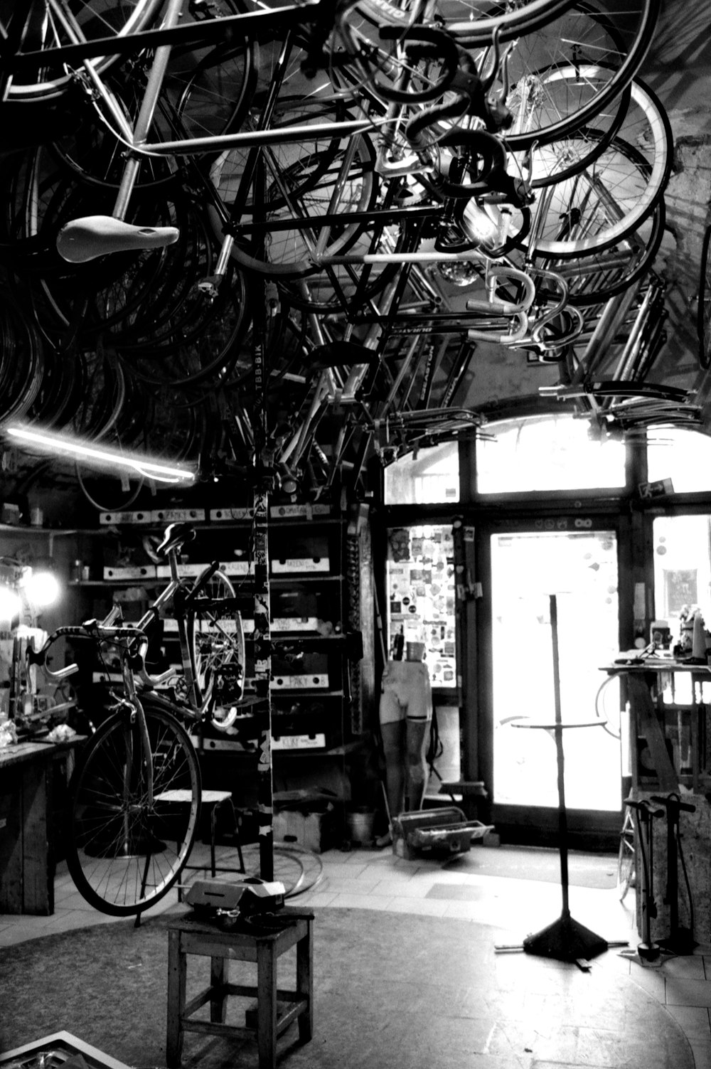 a room filled with lots of bikes hanging from the ceiling