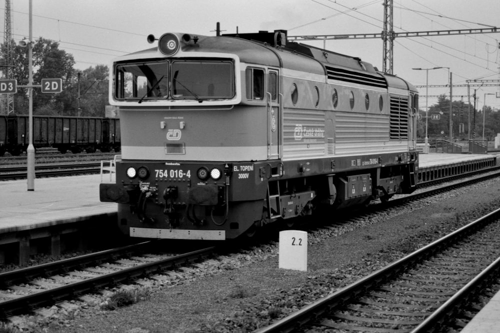 a black and white photo of a train on the tracks