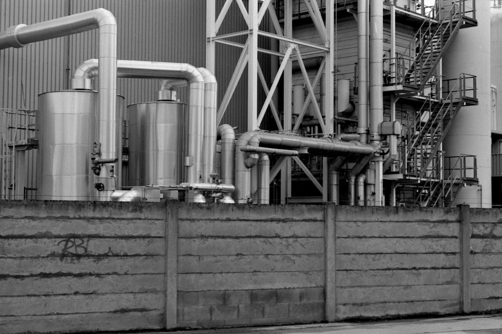 a black and white photo of a building with pipes