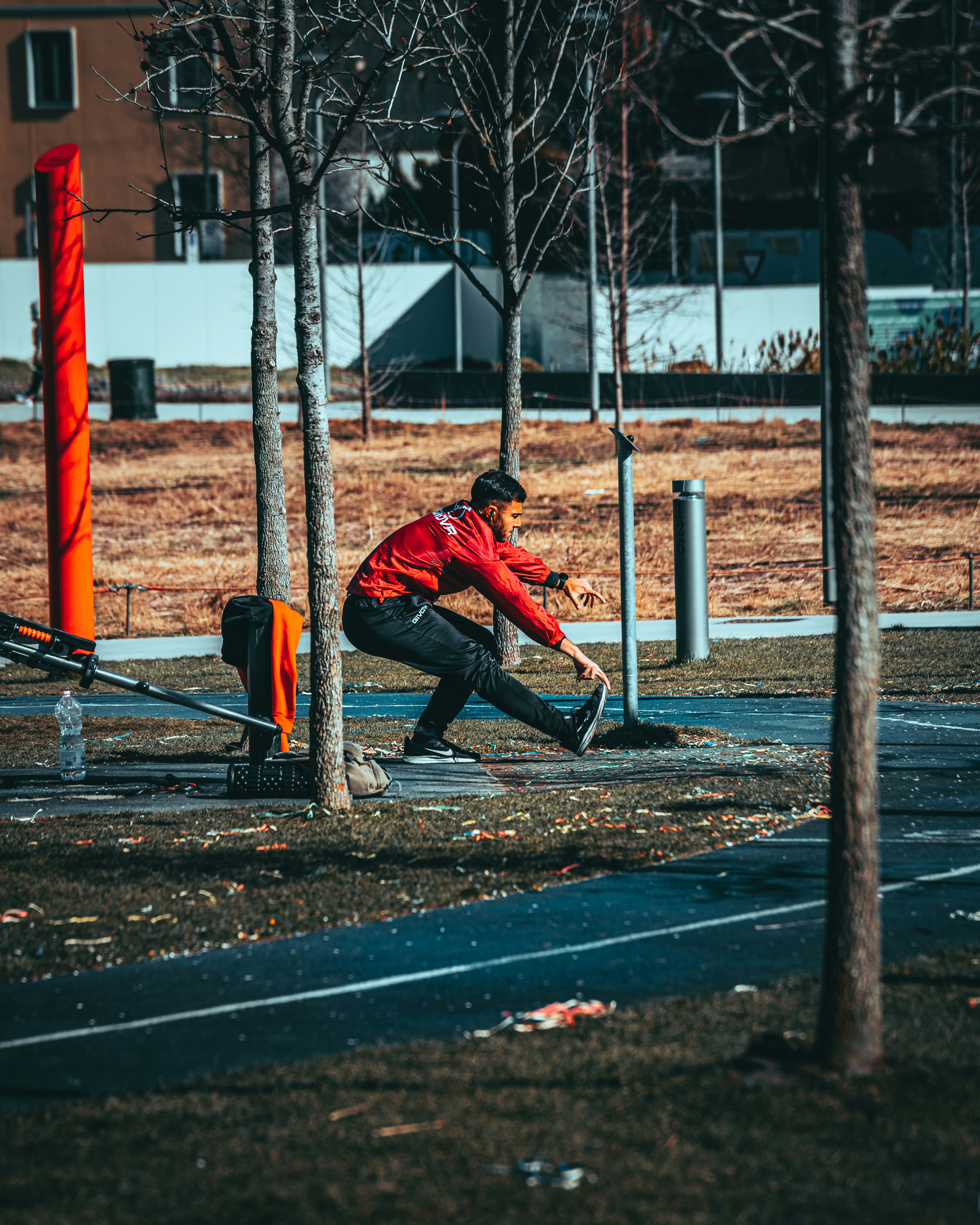 a man sitting on a bench in a park