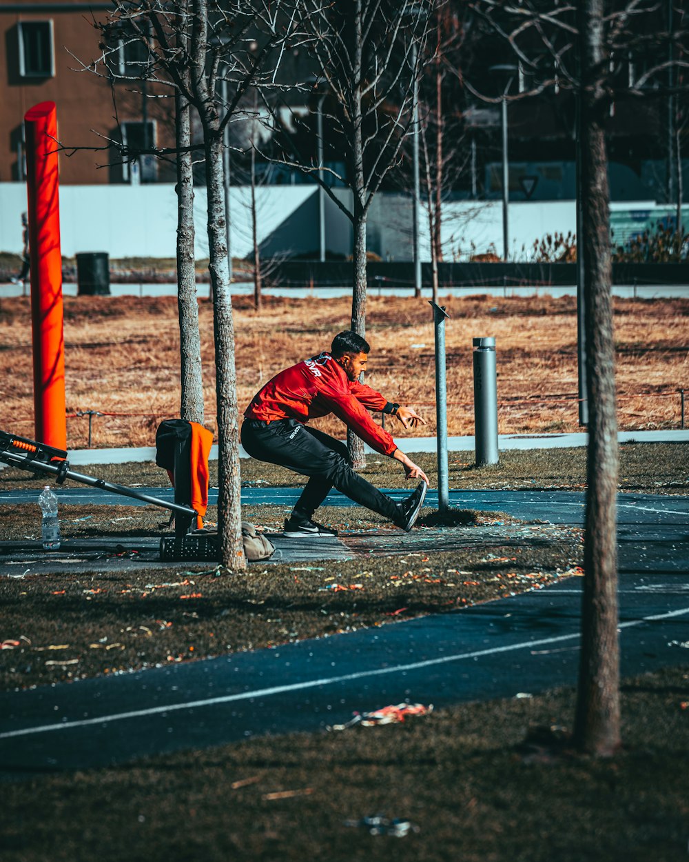 a man sitting on a bench in a park