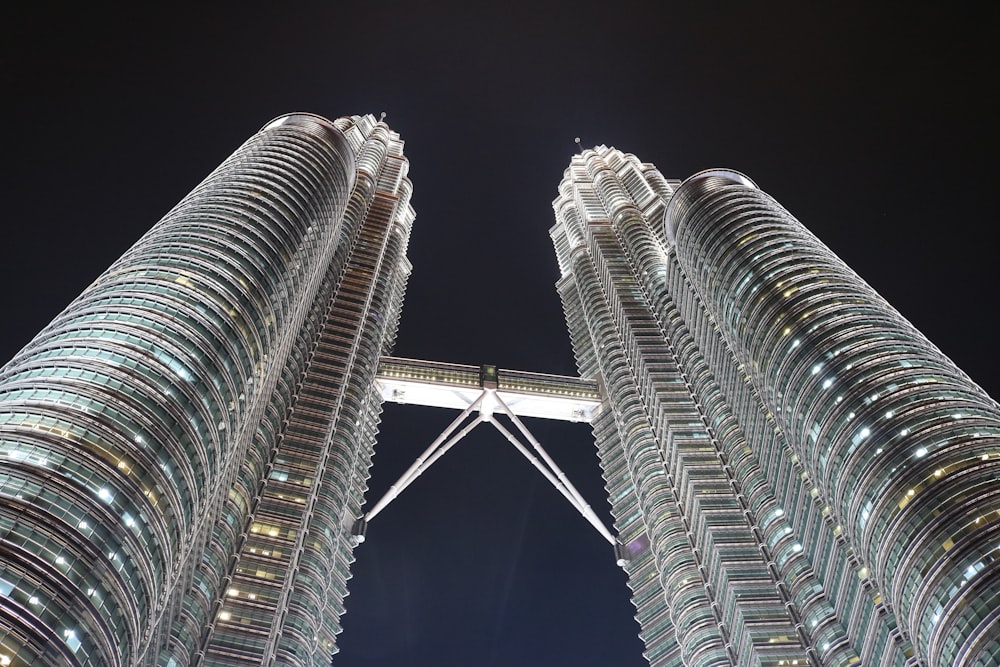 two very tall buildings towering into the sky