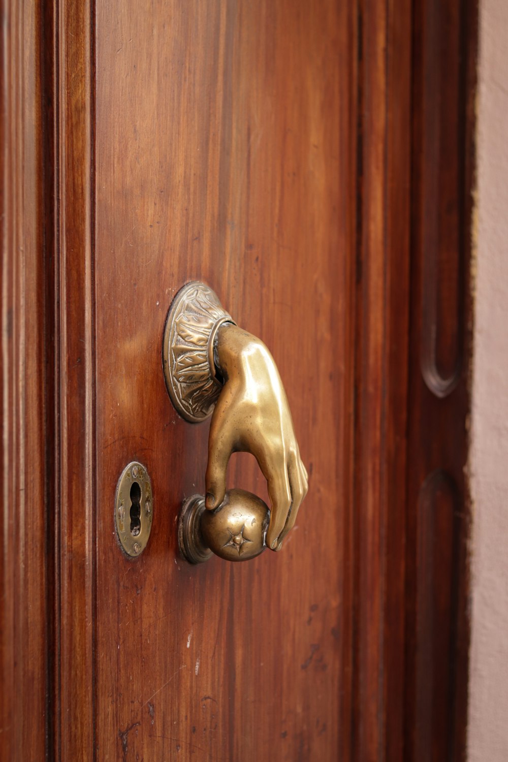 a close up of a door handle on a wooden door