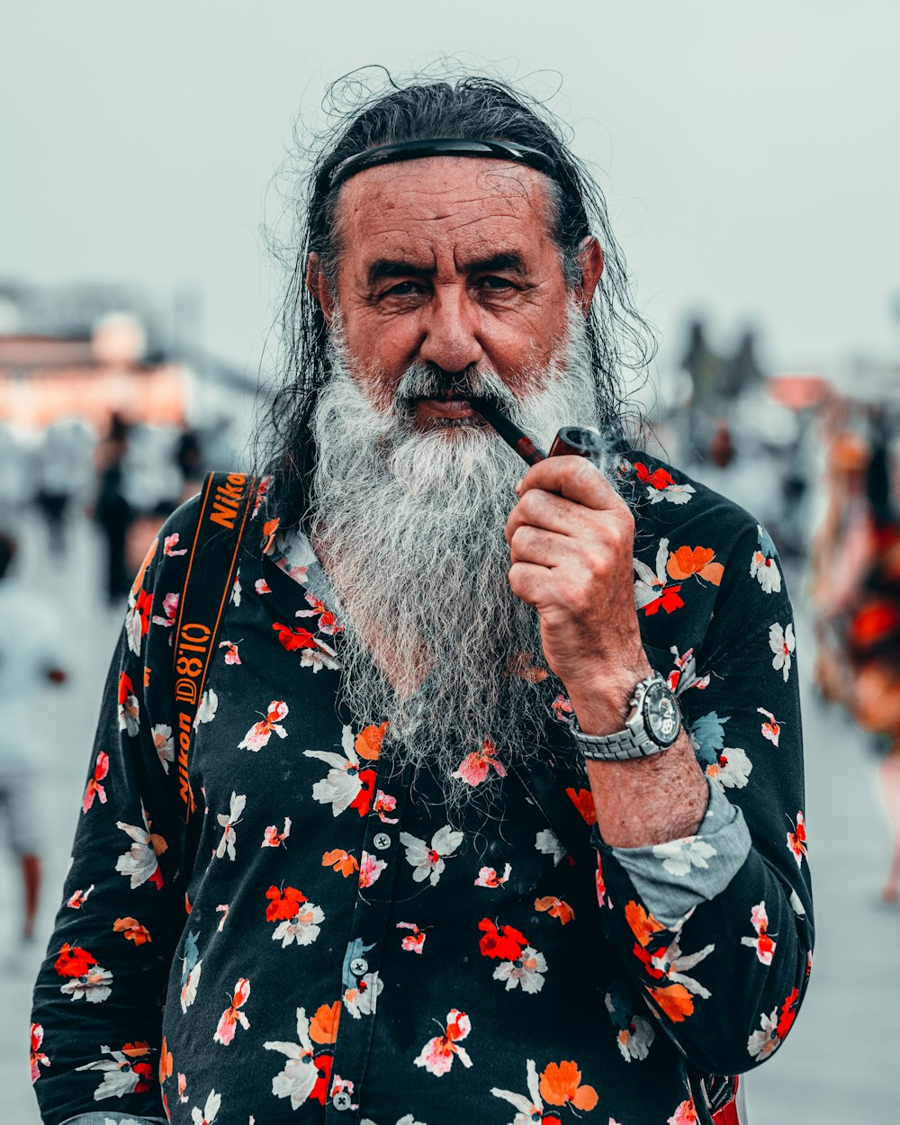 a man with a long white beard and a flower shirt