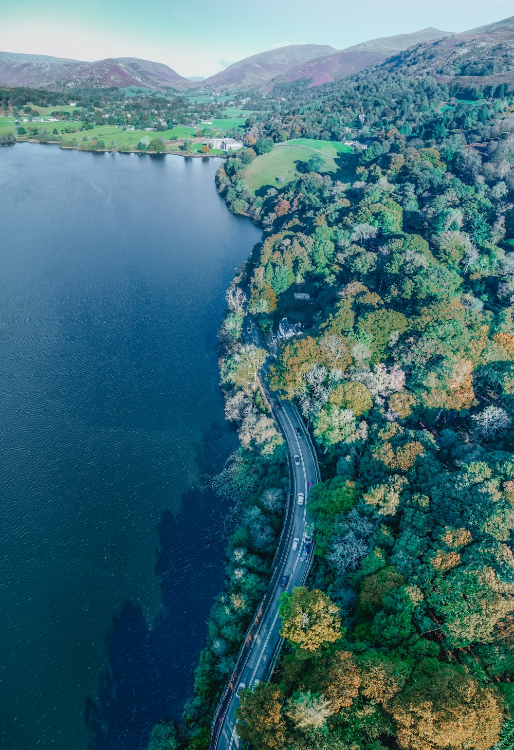 an aerial view of a winding road in the middle of a lake