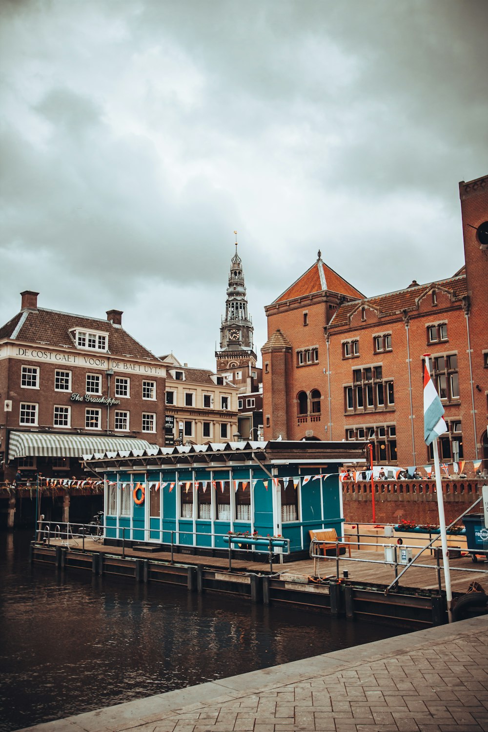 a boat is docked in the water next to a building