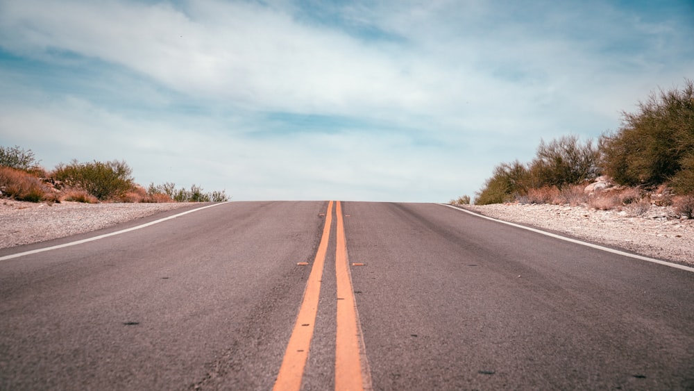 an empty road in the middle of a desert