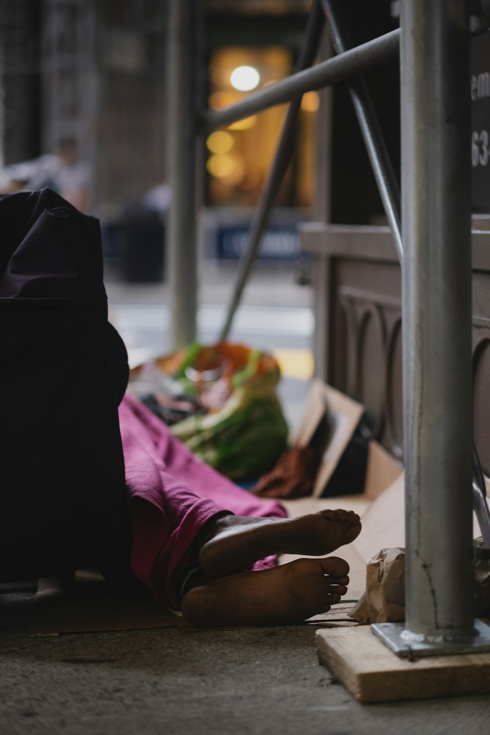 a person laying on the ground next to a building