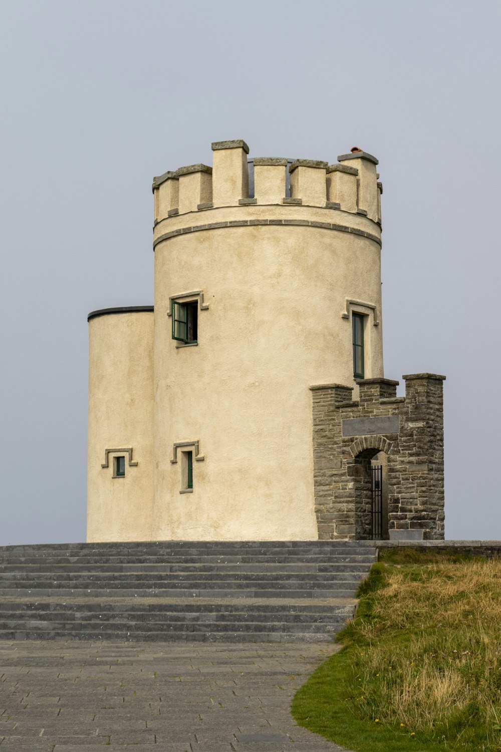 a tall white tower with a clock on it's side