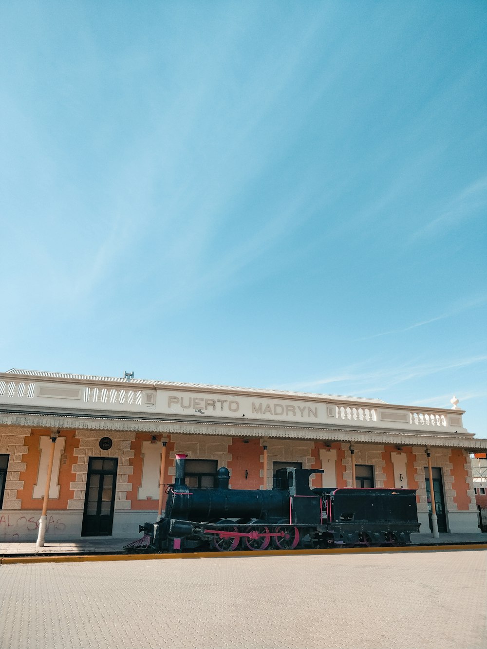 a train is parked in front of a train station