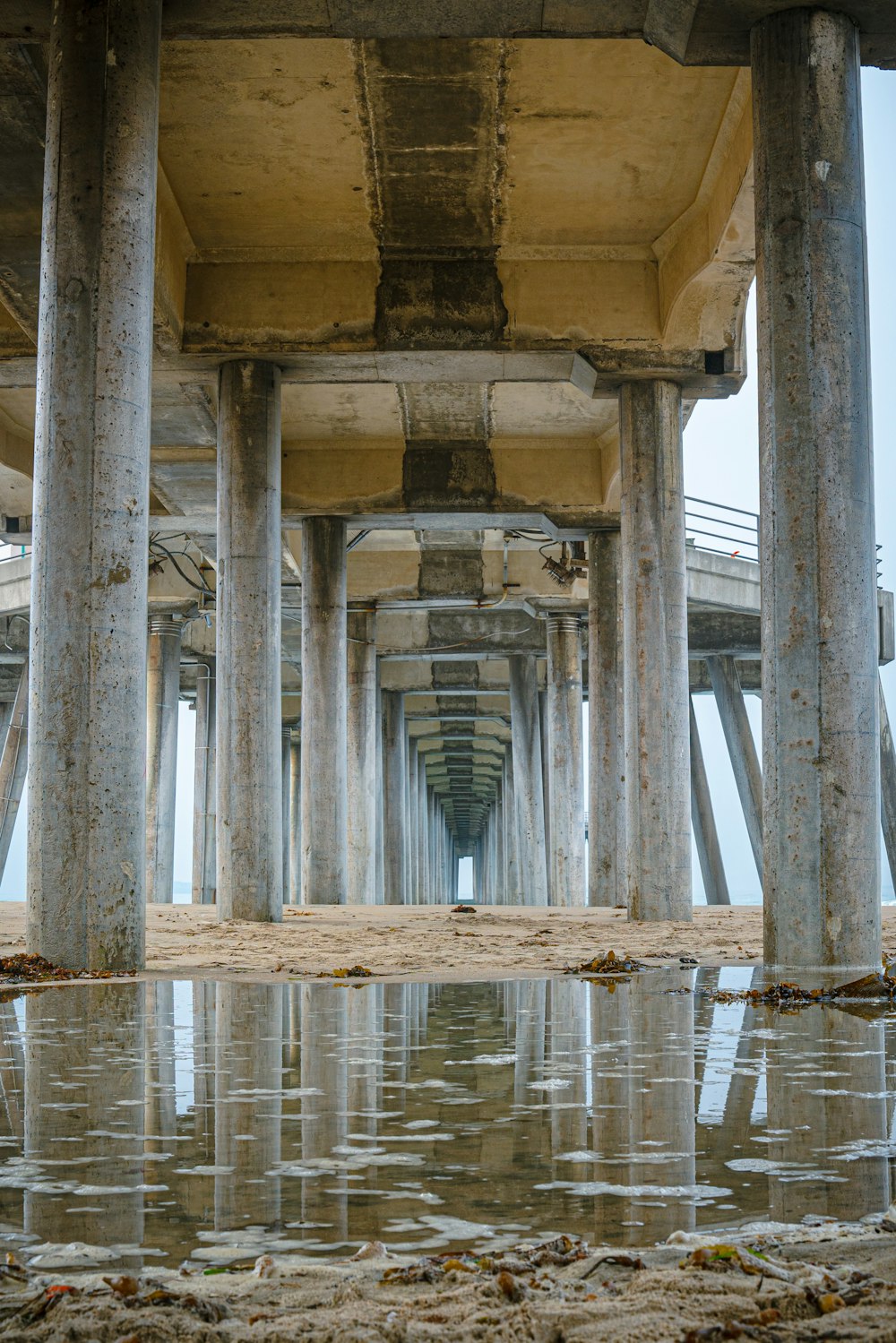 the underside of a pier with water under it