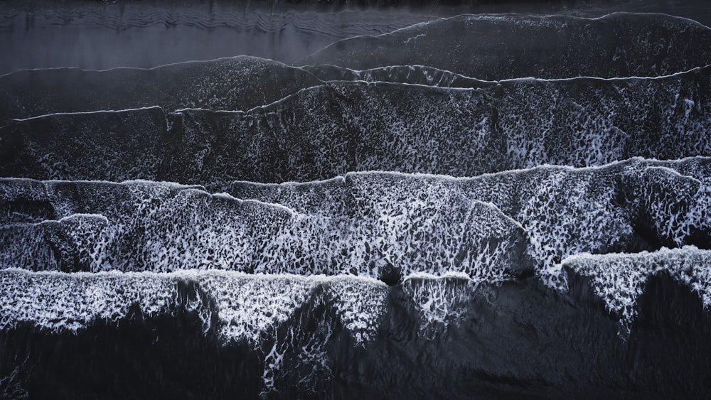 a black and white photo of the ocean waves