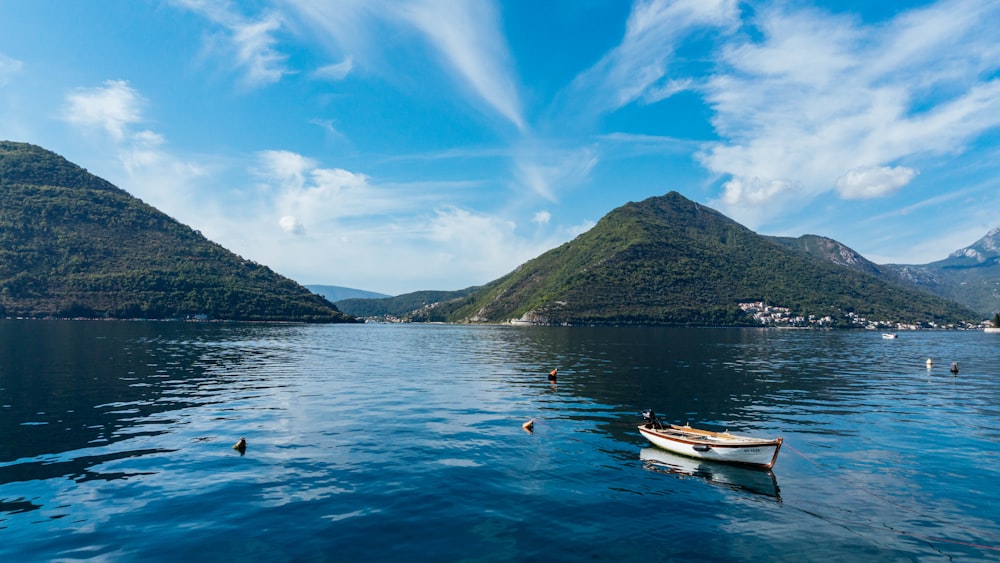 a small boat floating on top of a large body of water