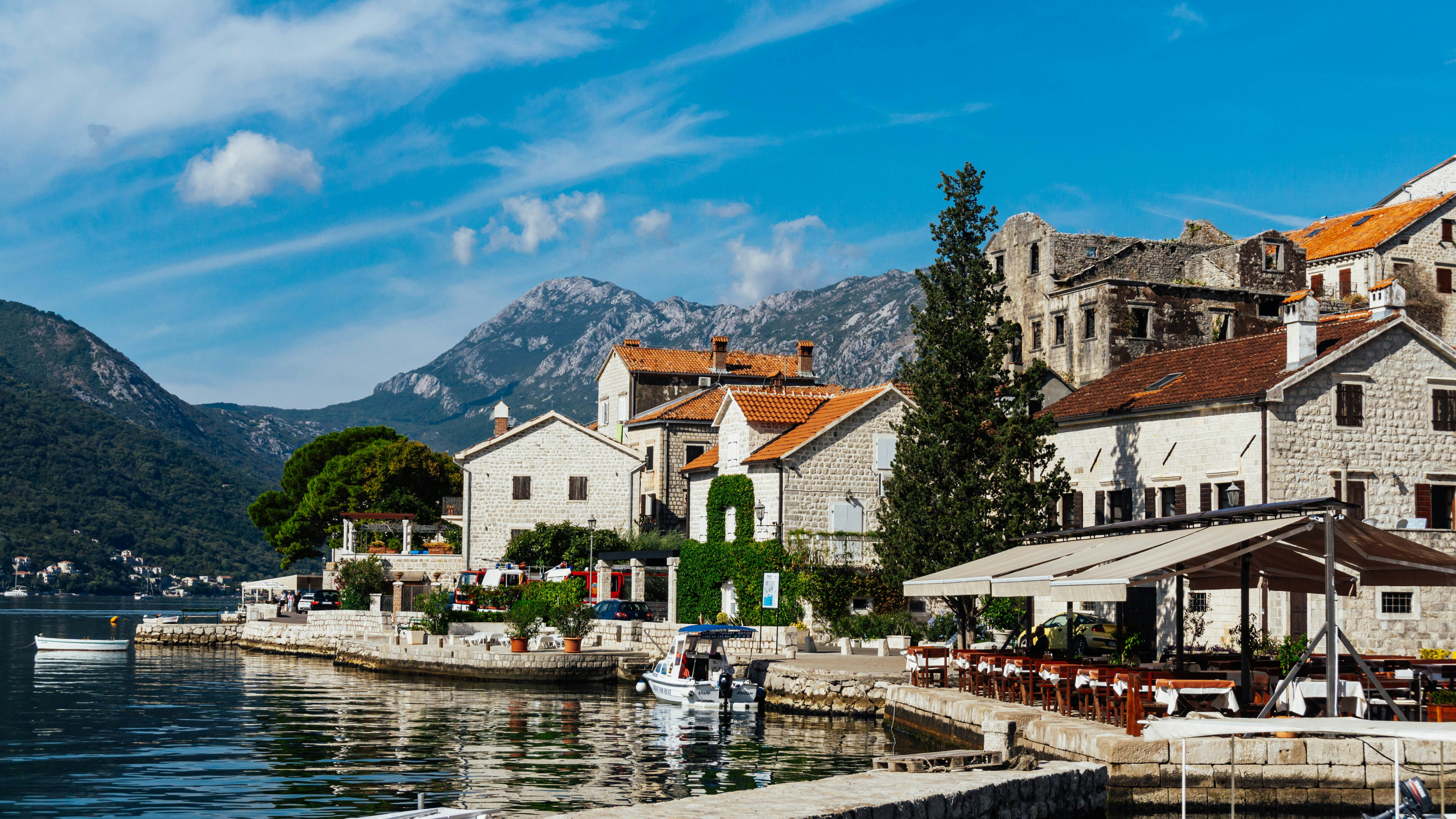 a group of buildings sitting next to a body of water, 