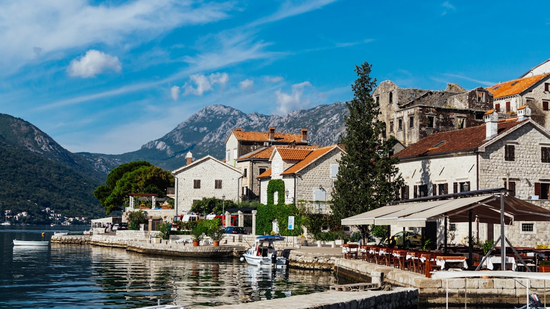 a group of buildings sitting next to a body of water,