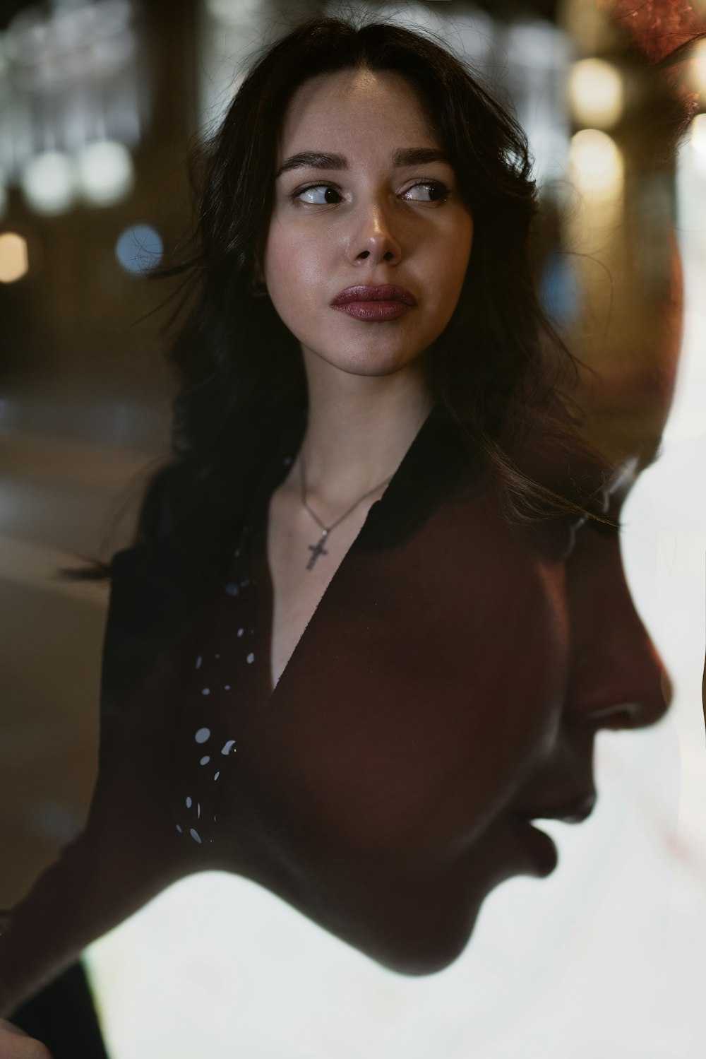 a woman standing in front of a window