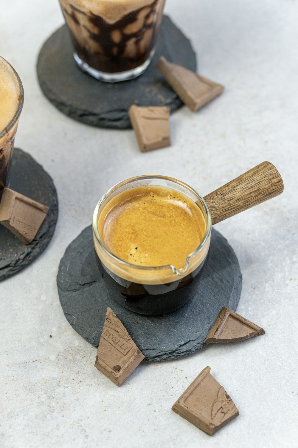 a couple of cups of coffee sitting on top of coasters