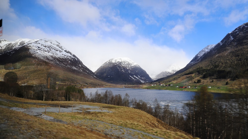 a scenic view of a mountain range with a lake in the foreground