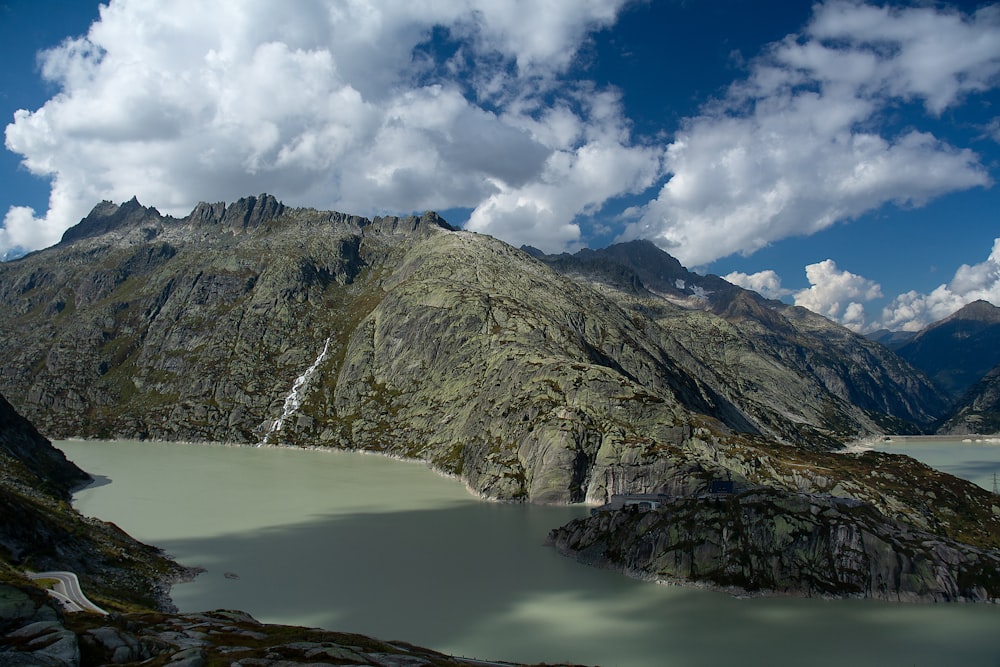 a mountain range with a lake in the foreground