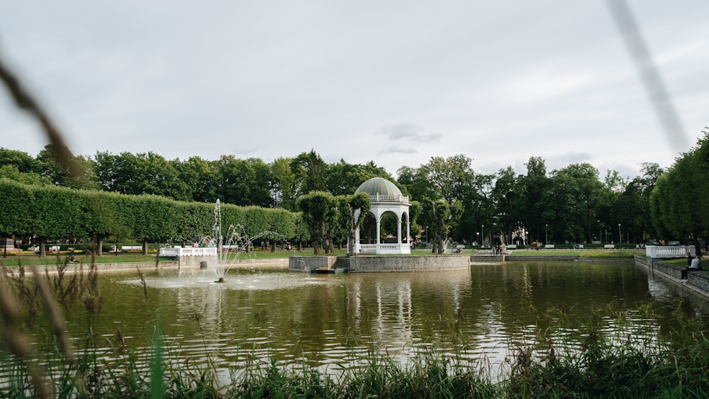 a pond with a gazebo in the middle of it