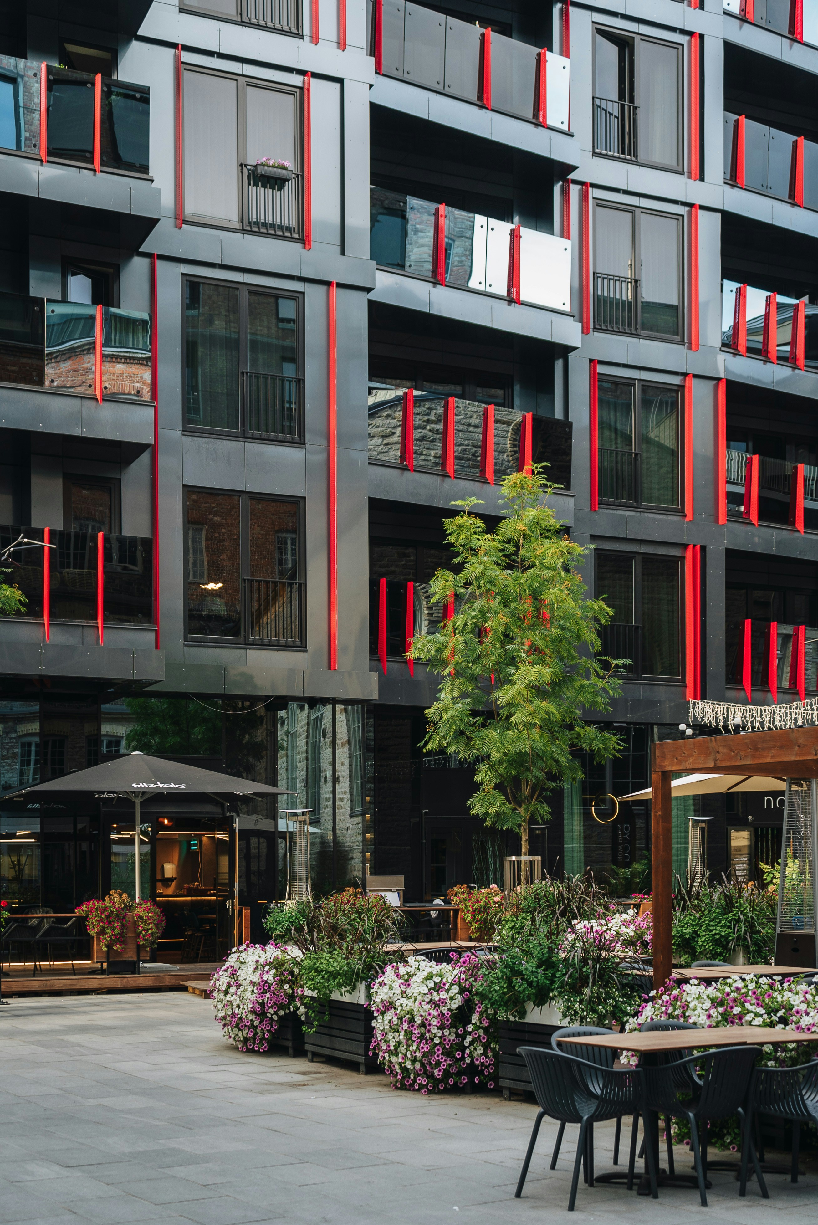 a building that has a bunch of tables and chairs in front of it