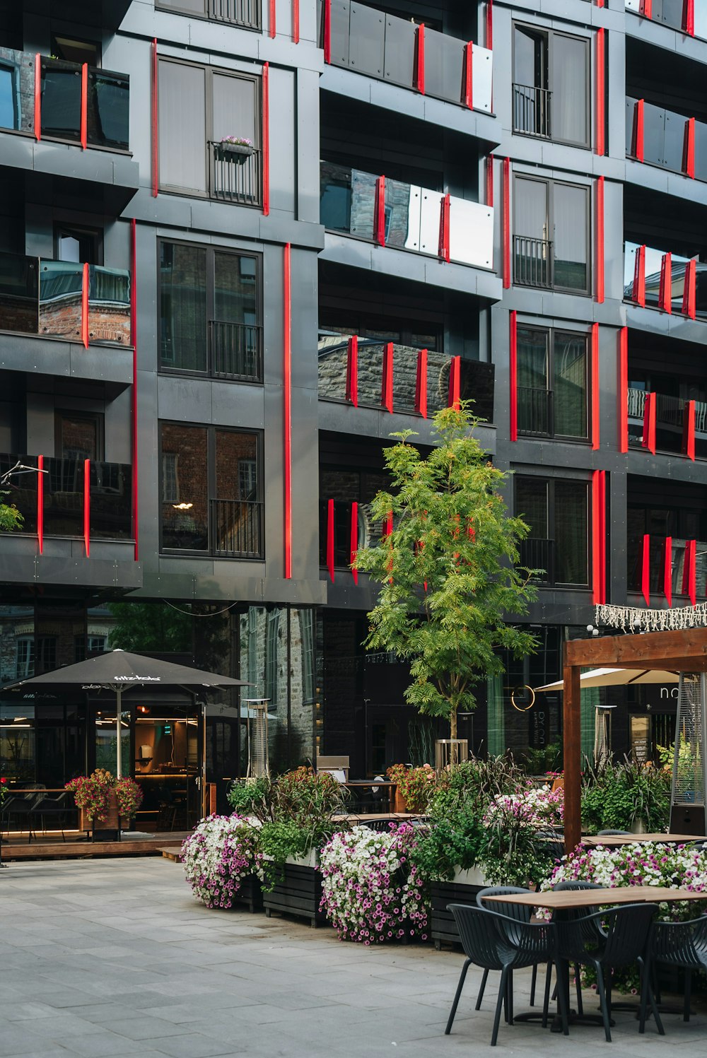 a building that has a bunch of tables and chairs in front of it