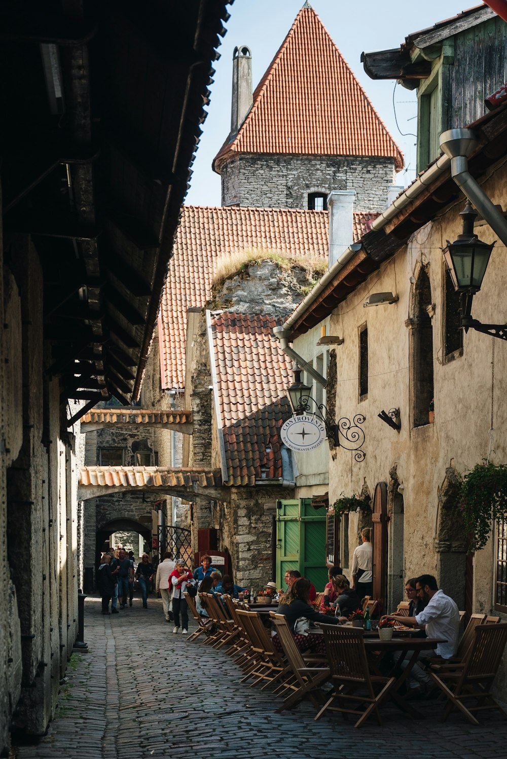 a cobblestone street lined with tables and chairs