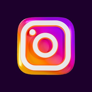 A colorful and glossy 3D representation of a familiar social media logo with a square shape featuring rounded edges and a stylized camera icon in the center. The logo has gradients of pink, purple, and orange with a shiny, reflective surface.