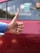 A smiling customer giving a thumbs up next to a car with a driver in uniform.