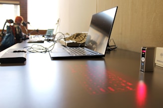a laptop computer sitting on top of a wooden desk