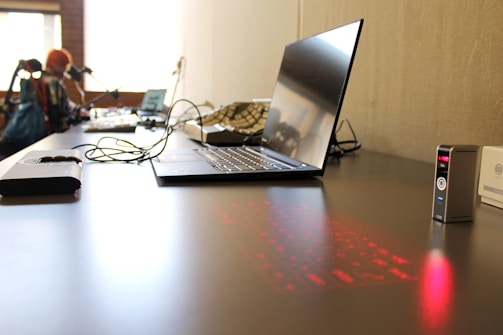 a laptop computer sitting on top of a wooden desk