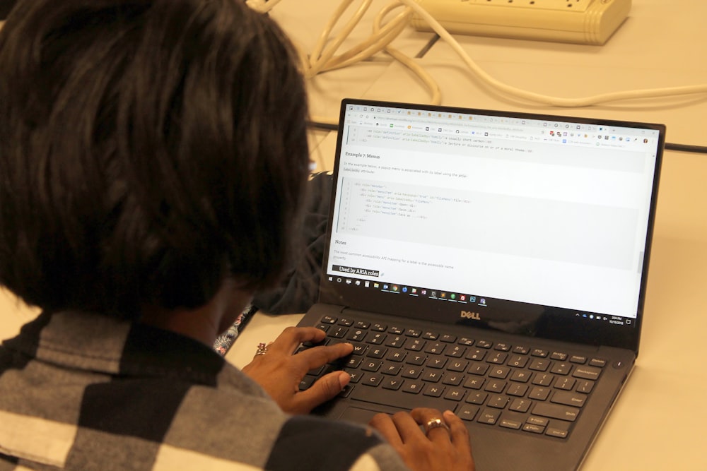 a person sitting in front of a laptop computer