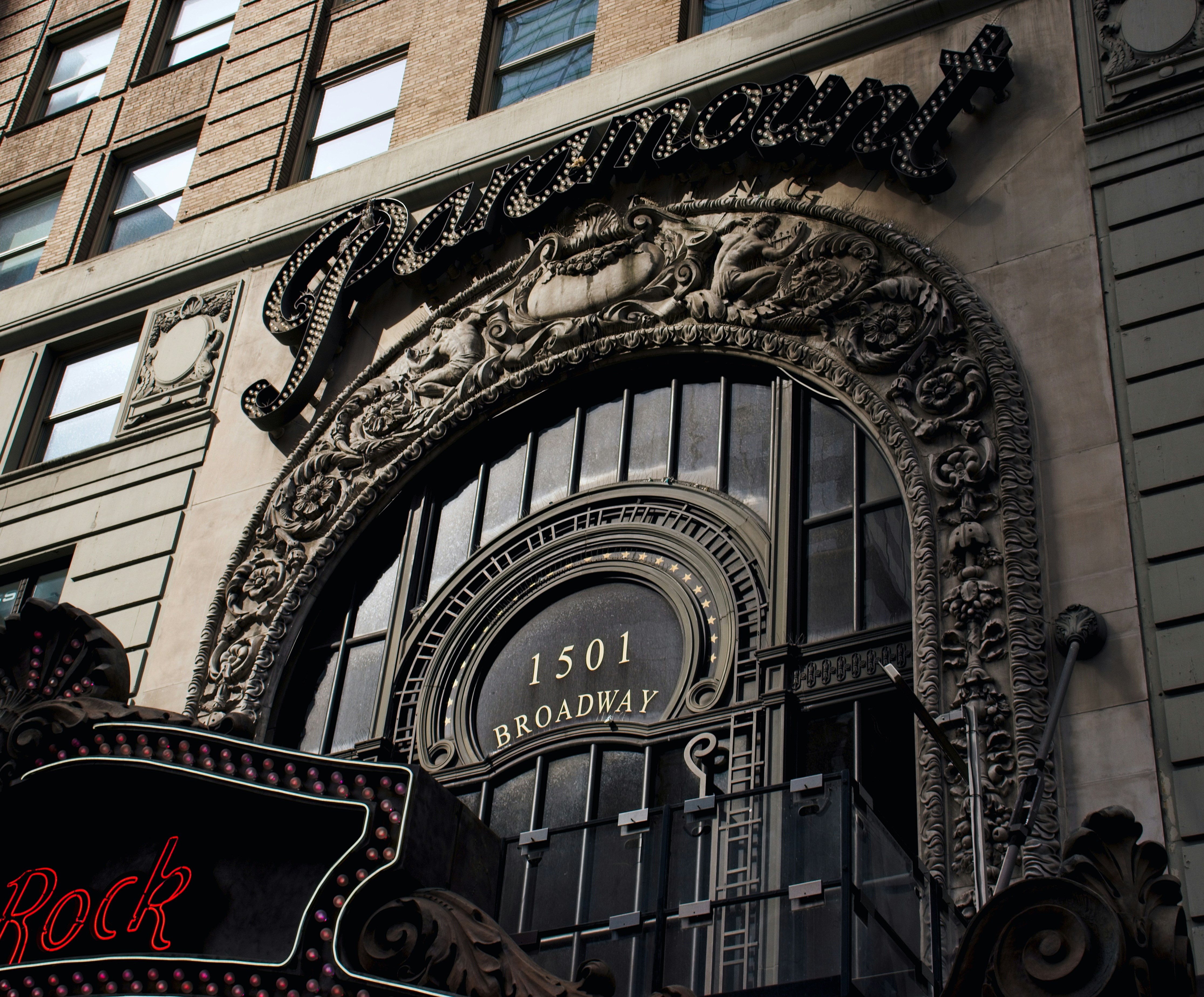 the entrance to a building with a clock on it, 
