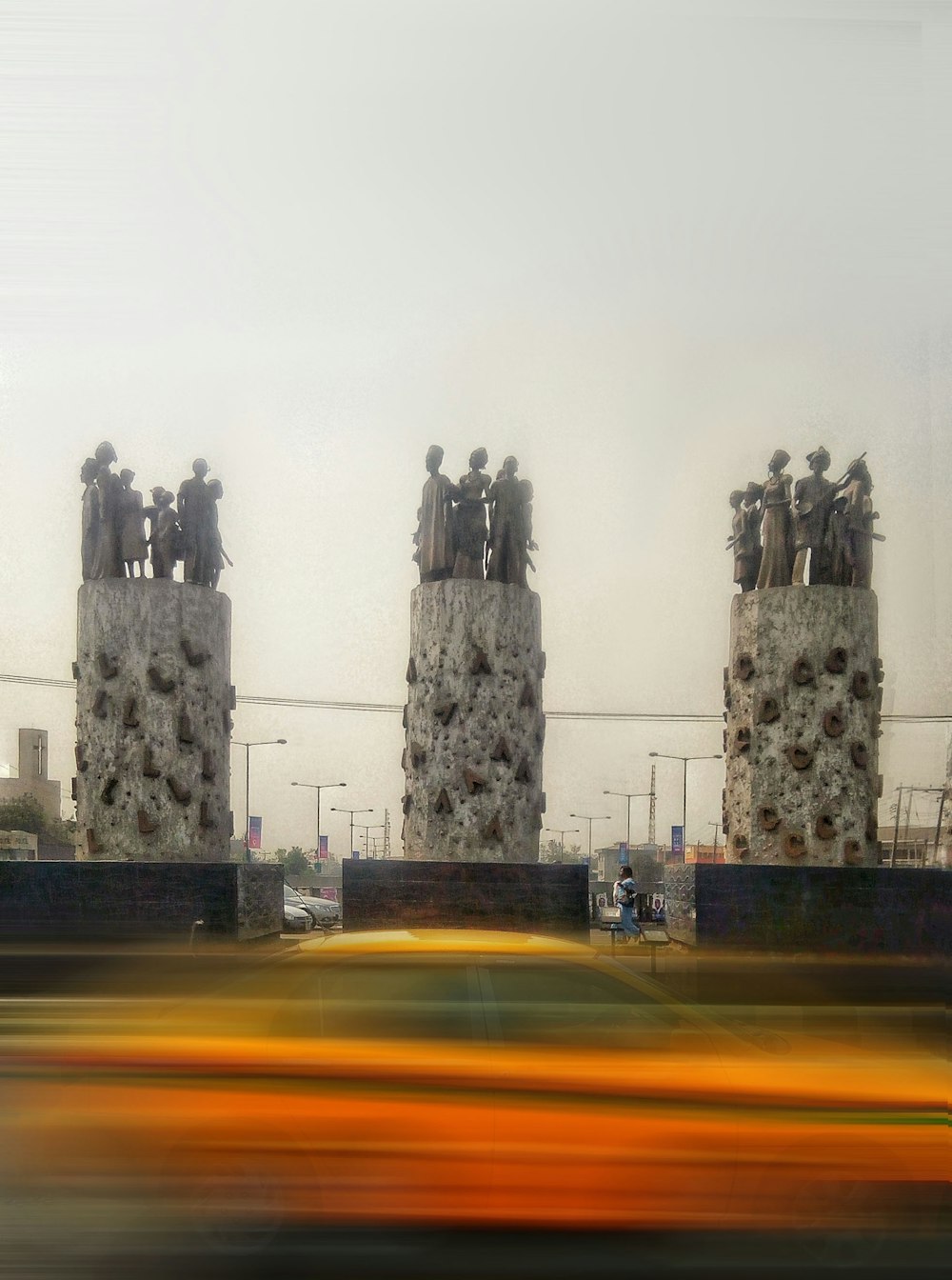 a blurry photo of a car passing by a monument