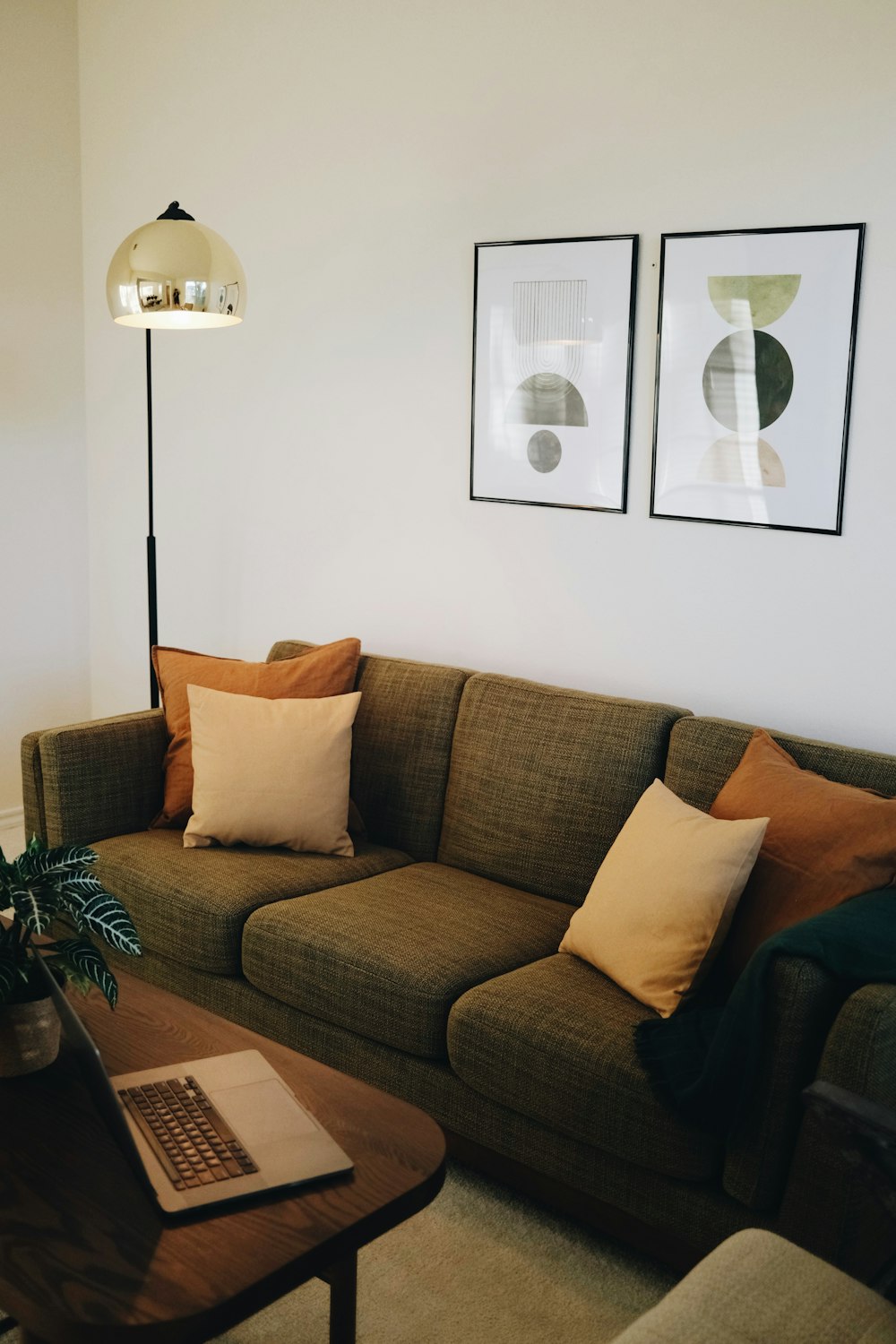 a living room with a couch and a laptop on a table