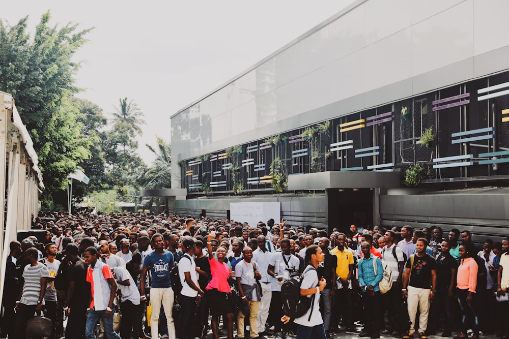 a large group of people standing in front of a building