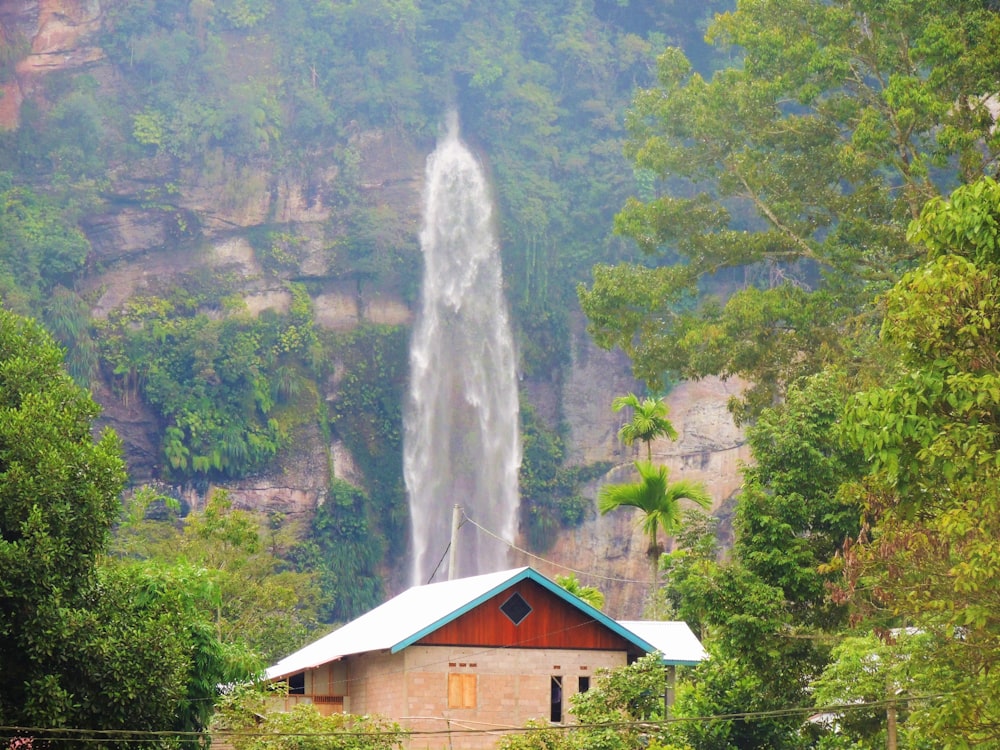 a house with a waterfall in the background