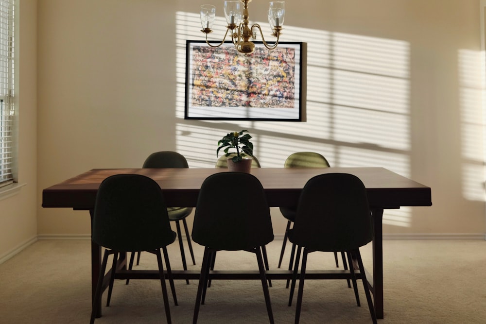 a dining room table with chairs and a chandelier