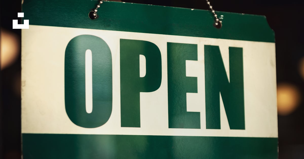A green and white open sign hanging from a chain photo – Free ...