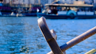 A calm river scene with a wooden oar resting gently on a small boat, symbolizing guidance and support.