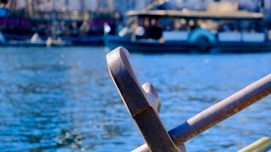 A calm river scene with a wooden oar resting gently on a small boat, symbolizing guidance and support.