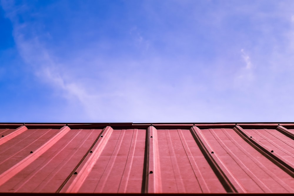 a red roof with a blue sky in the background