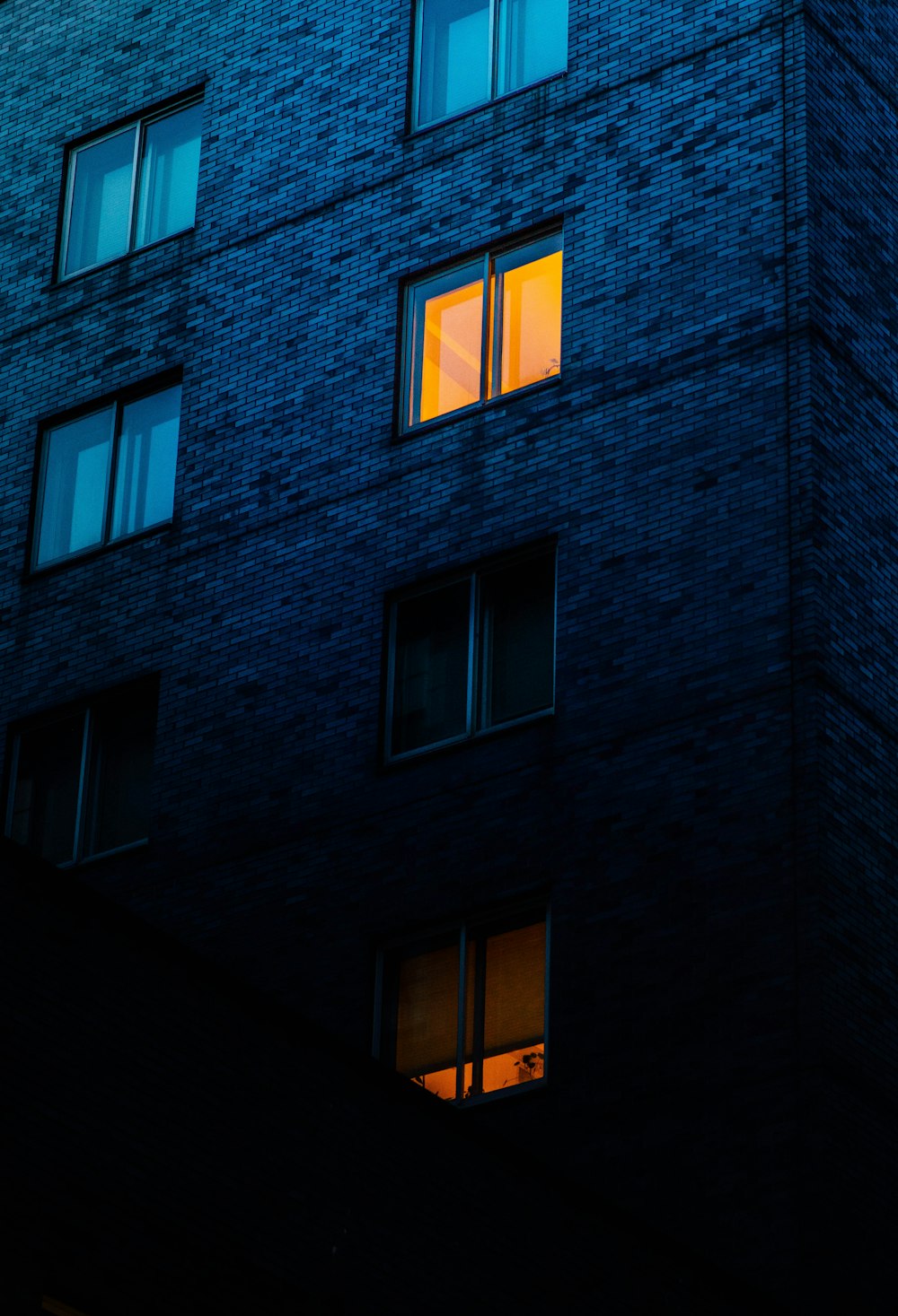 a tall building with windows lit up at night